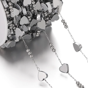 Macro shot of stainless steel heart chain and bead roll for DIY jewelry making