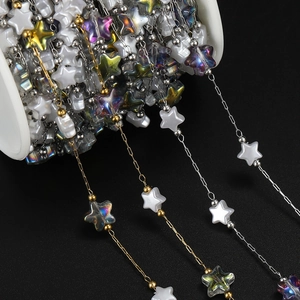 Detail of 18K gold and silver star chains with matte and AB clear acrylic charms