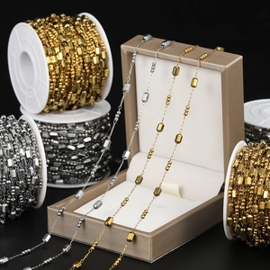 Macro detail of gold and silver beaded chains on rolls for DIY jewelry making and crafts