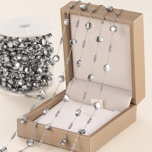 Close-up of silver oval bead chain on a jewelry box for DIY necklace and bracelet crafting