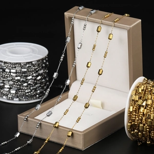 Macro detail of gold and silver cylinder bead chain for DIY jewelry making