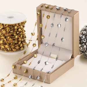 Macro shot of gold and silver faceted bead chains for DIY jewelry making displays