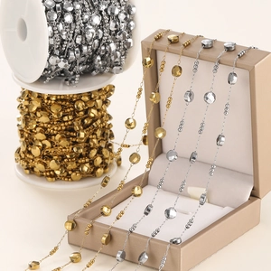 Detailed view of gold and silver oval bead chains for DIY jewelry making
