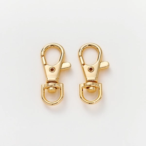 Detailed view of two 14K gold plated swivel lobster claw clasps with D-ring connectors