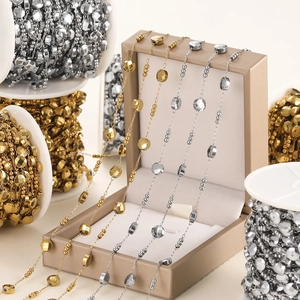 Detail of gold and silver beaded oval link chain on a jewelry box for DIY accessory making