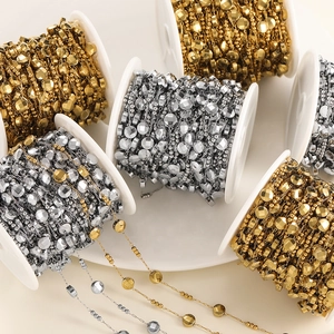Macro shot of gold and silver vacuum plated stainless steel oval bead chains for DIY jewelry