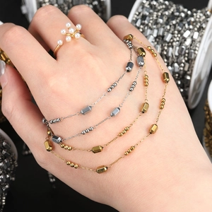 Detail of adjustable gold ring with six pearl flower cluster design and metal chains