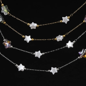 Close-up of 18K gold and silver star chains with acrylic pearls for DIY jewelry making