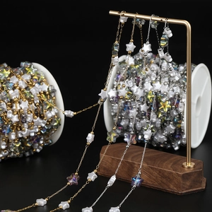 Detailed view of DIY star-shaped acrylic beads on 18K gold and silver stainless steel chains
