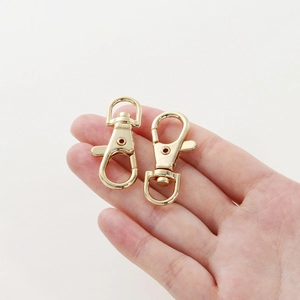14K gold plated lobster swivel clasp with D-ring for bags and pet leashes on hand