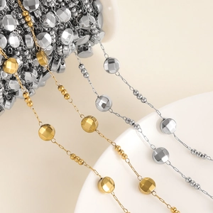 Macro shot of gold and silver beaded metal chains for DIY jewelry making on a spool