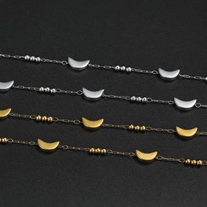 Detail of stainless steel moon and star bead chains in gold and silver finishes