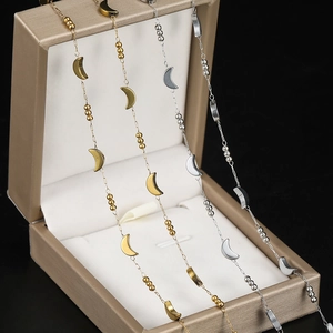 Detail of stainless steel moon and bead chains in gold and silver finish on gift box