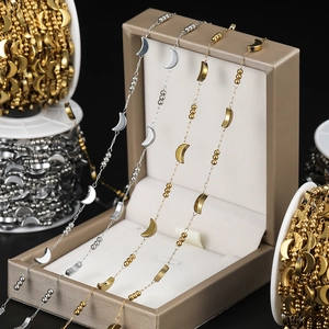 Close-up of crescent moon and bead chain in gold and silver for DIY jewelry making