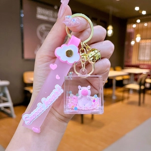 Close-up of pink Capybara oil liquid keychain with floating glitters and sweet heart strap