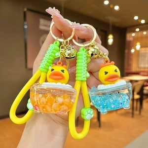 Cute yellow duckling bathtub keychain with liquid oil, golden bell and silicone wrist strap