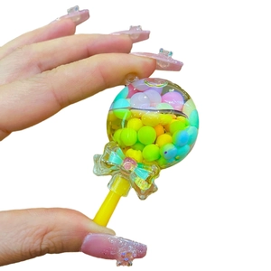 Lollipop keychain featuring colorful macaron beads inside a transparent globe and a bow charm