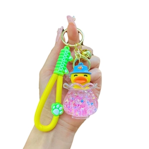 Glow-in-the-dark little yellow duck bathtub keychain with pink glitters and green strap