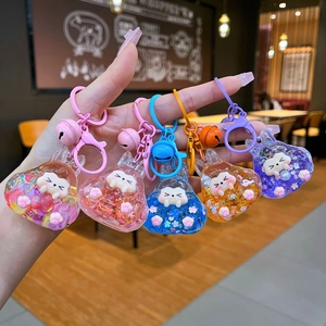 Close-up of five colorful liquid glitter keychains with charms and lobster clasps