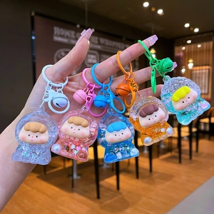 Set of five colorful acrylic quicksand doll keychains with bells and glitter charms