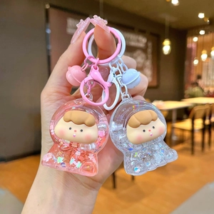 Cute astronaut liquid quicksand keychain in pink and white acrylic with star glitter charms