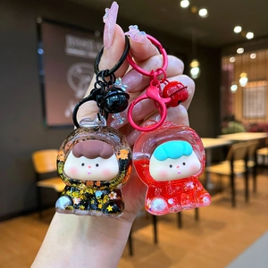 Detail of cute acrylic liquid quicksand keychains with floating glitter and cartoon figures