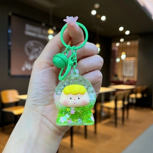 Close-up of cute cartoon liquid quicksand keychain with green glitter and pink star charm