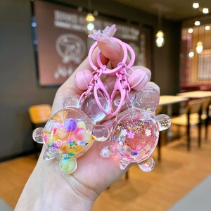 Cute cartoon turtle keychains with glitter stars and colorful beads in a set of two