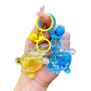 Glittering turtle keychains in blue and yellow with resin sequins and small bells