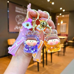 Quicksand acrylic keychains with purple and orange glitter figurines and silicone straps