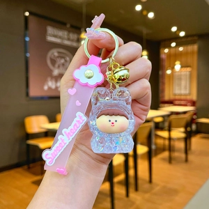 Close-up of Lilith liquid sand keychain with acrylic figure and pink sweet heart wristband