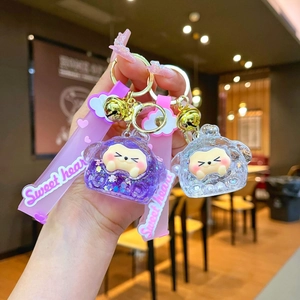 Close-up of a purple glitter liquid quicksand acrylic keychain with Sweet heart strap