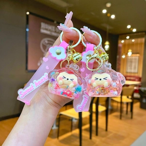 Detail of acrylic shaker keychain with pink glitter strawberry and Sweet Heart wristlet