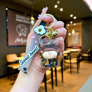Detail of Lilith quicksand keychain with sweet heart strap and golden bell charm
