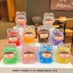 Ten colorful resin bunny figurines in various vibrant glitter finishes on tiered stands