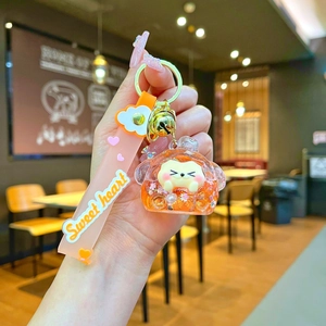 Detail of cute hamster animal keychain with orange liquid glitter and sweet heart wristlet