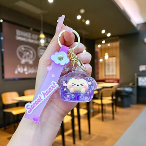 Close-up of a purple cartoon sheep keychain with glitter oil and Sweet Heart wrist strap