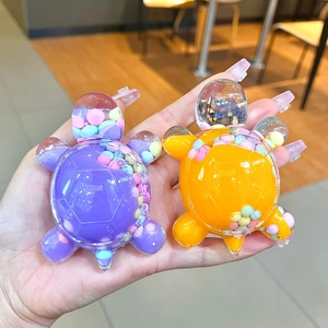 Macaron liquid quicksand turtle keychain in purple and orange with colorful moving beads