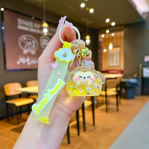 Detail of yellow liquid acrylic keychain with sequins, pearls and sweet heart strap