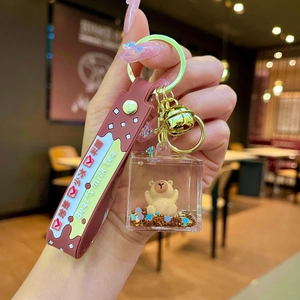 Brown Bear milk tea themed keychain with floating liquid sand and golden bell charm