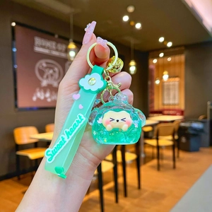 Detail of mint green liquid glitter keychain with cute hamster and Sweet Heart strap