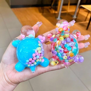 Macro shot of liquid glitter turtle keychains in blue and clear macaron colors