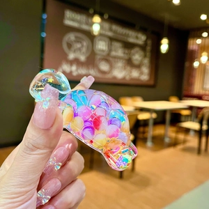 Macro detail of transparent turtle fidget toy filled with vibrant colorful beads