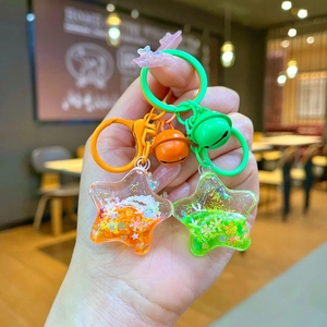 Sparkly star liquid glitter keychains in orange and green with colorful bell charms