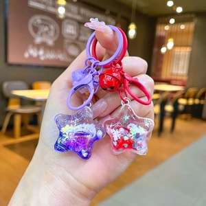 Star-shaped liquid glitter keychain with colorful sequins and beads in red and purple