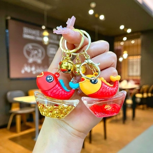 Cute koi fish and gold ingot keychains with lucky charms in red and yellow colors
