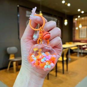 Close-up of a liquid shaker keychain with orange snowflakes and colorful beads