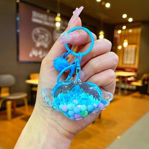 Cute heart-shaped keychain with angel wings and blue liquid glitter inside