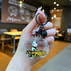 Close-up of acrylic panda keychain with black liquid, gold stars and matte clasp