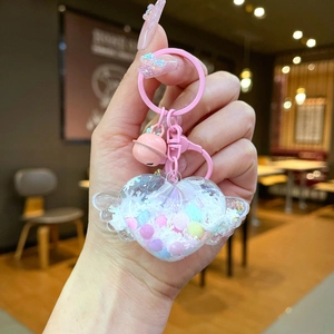 Pink heart-shaped liquid quicksand keychain with wings and colorful beads